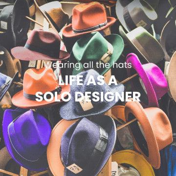 Photo of hats on a rack by JOSHUA COLEMAN unsplash.com/@joshstyle -blog post about life as a solo designer by Gigglemugg. 5 things to help navigate the solopreneurial journey.  