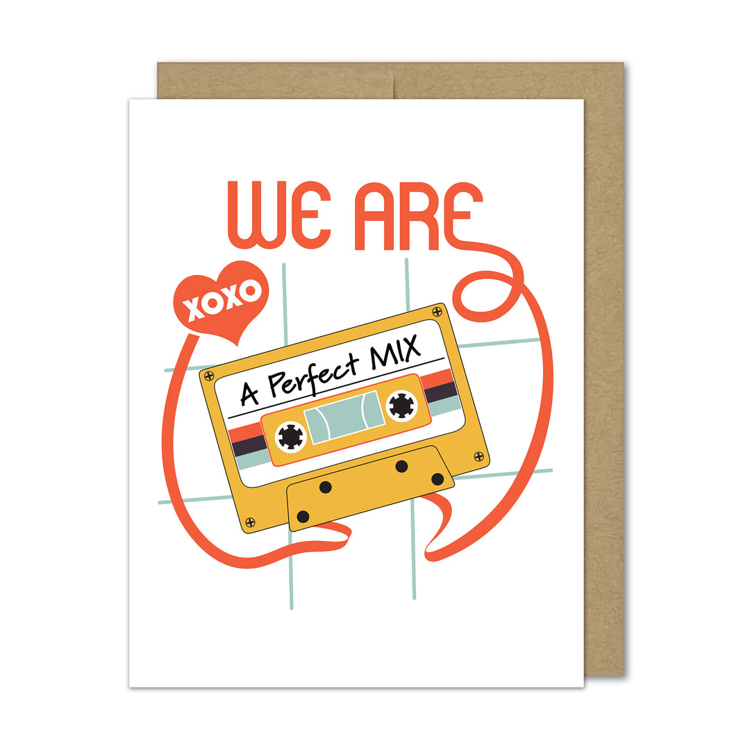 Greeting card with a cassette tape design and 'We Are A Perfect Mix' text with a kraft envelope on a white background.