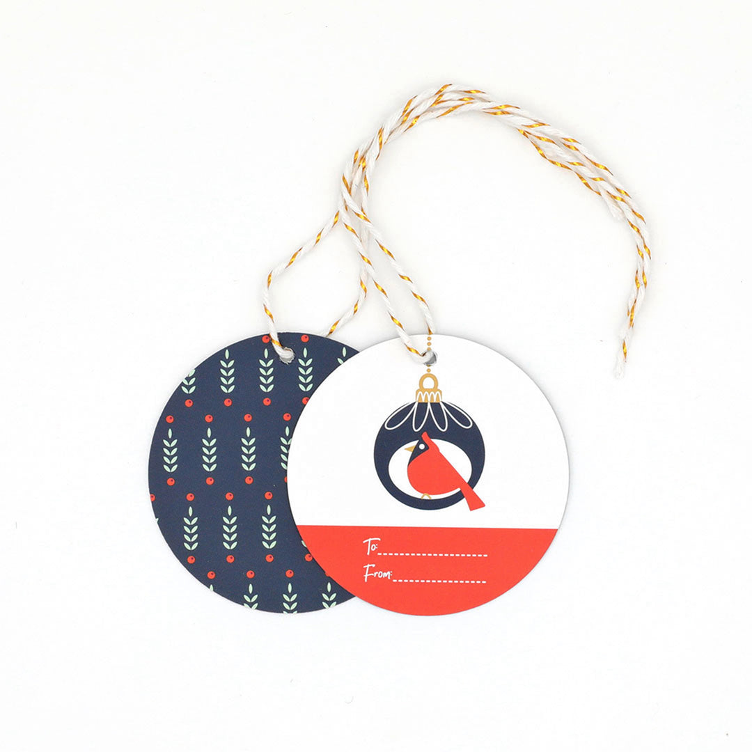 Round gift tags with a red bird design on front and a festive pattern on the back on a white background