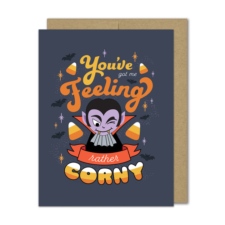 Halloween-themed greeting card with cartoon vampire and candy corns on a dark blue background.