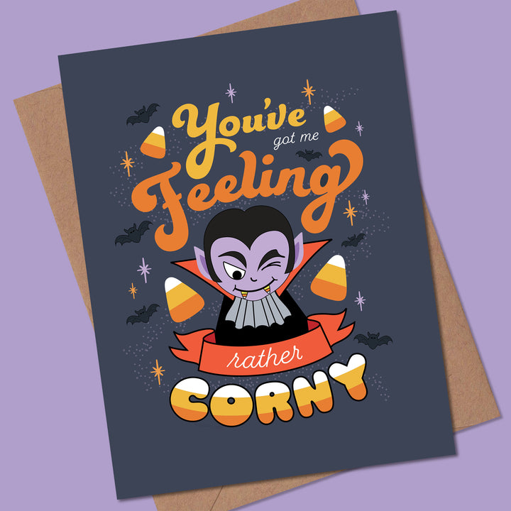 Halloween-themed card with cartoon vampire and candy corn on a purple background