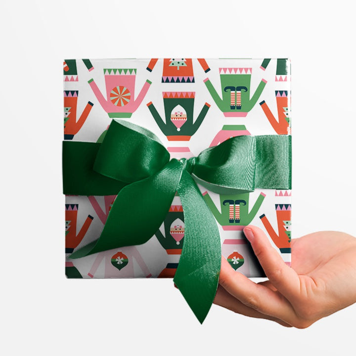 Holiday gift wrapped in a festive sweater wrapping paper by Gigglemugg