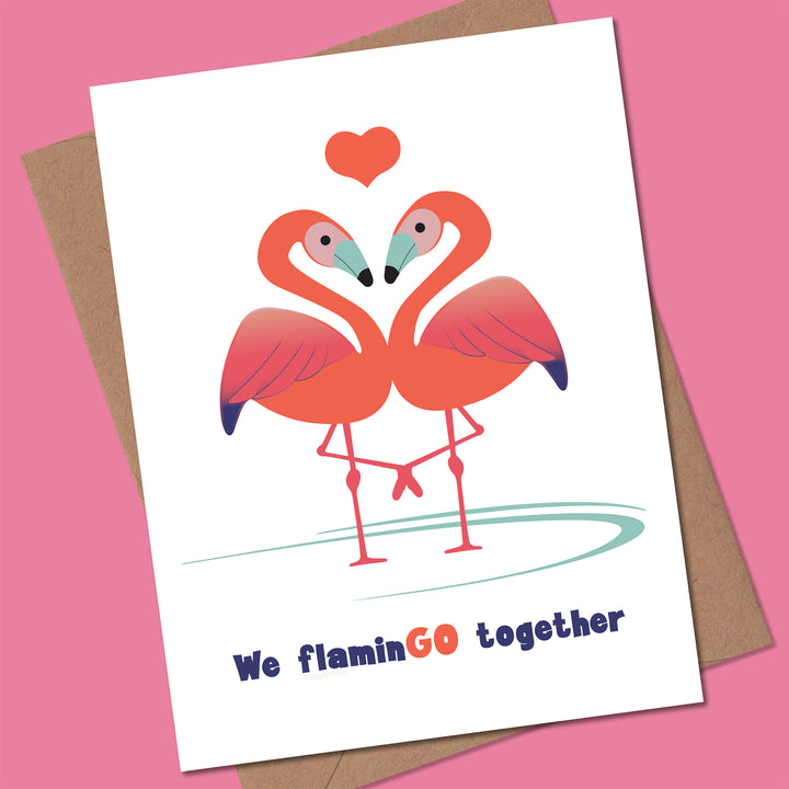 Card with two flamingos and a heart, with text &