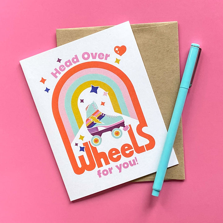 Greeting card with rainbow design and text on a pink background