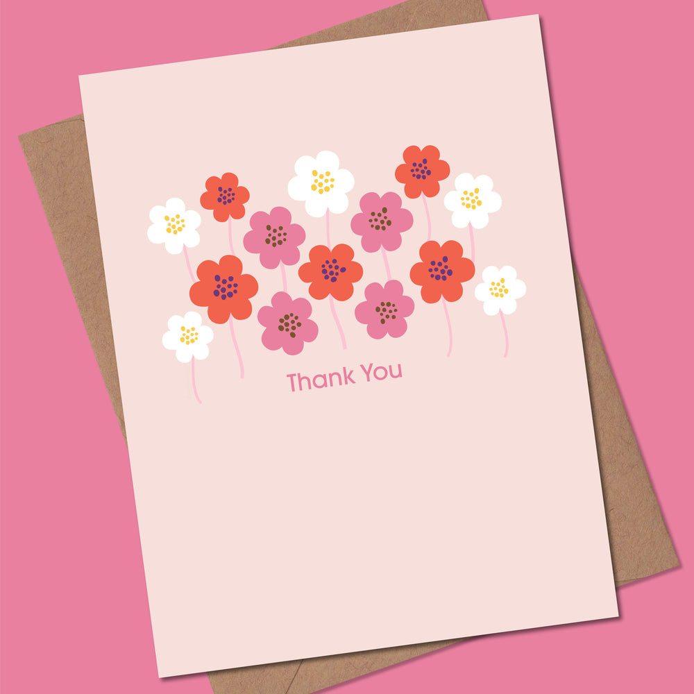 Greeting card with floral design and 'Thank You' text on a pink background
