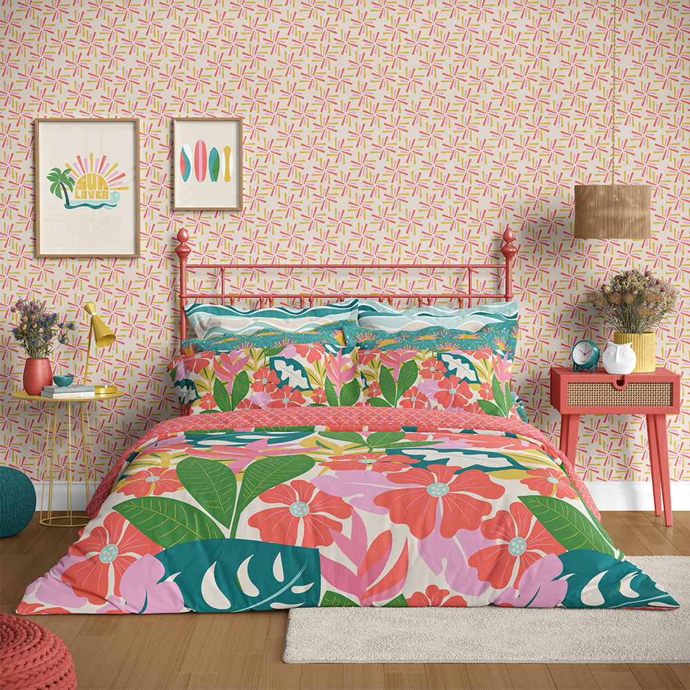 Bedroom with tropical floral bedding and red metal bed frame against a modern patterned wall by ©Gigglemugg
