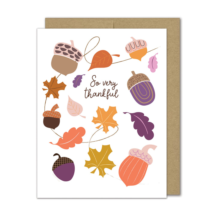 Greeting card with autumn-themed design featuring acorns and leaves on a white background.