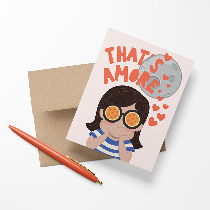 Greeting card with illustrated girl character with pizza eyes standing in front of the moon with saying, "That&