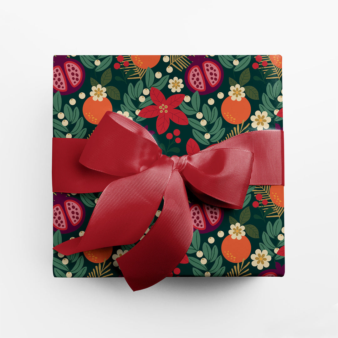 Gift wrapped in winter floral holiday wrapping paper with red ribbon.