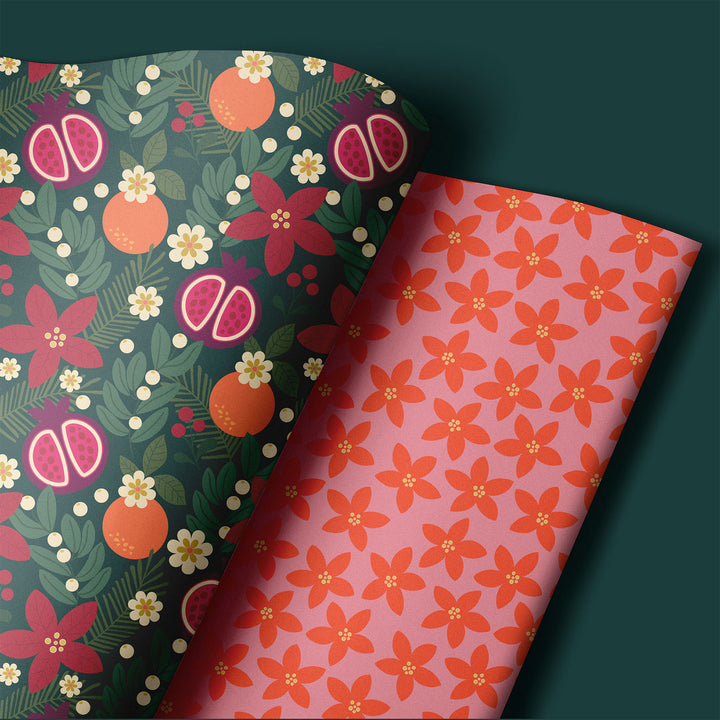 Two holiday floral-patterned wrapping paper sheets on a dark green background